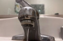 Water flows from a faucet.