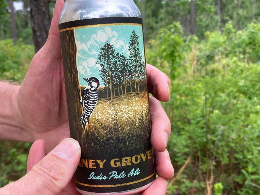 Each beer can is illustrated with a colorful rendering of the ecosystem the Nature Conservancy is working to protect.