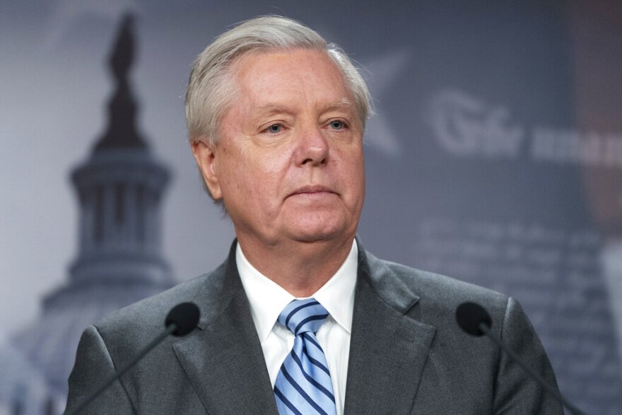 FILE - Sen. Lindsey Graham, R-S.C., speaks with reporters about aid to Ukraine, on Capitol Hill, Wednesday, March 10, 2022, in Washington. Attorneys representing Graham said Wednesday, July 6, that he intends to challenge a subpoena compelling him to testify before a special grand jury in Georgia investigating former President Donald Trump and his allies' actions after the 2020 election. (AP Photo/Alex Brandon, File)