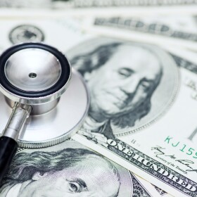 Stethoscope on the dollars. Medical costs. Healthcare payment concept. Concept of analysis of the market and economy and interest rates.