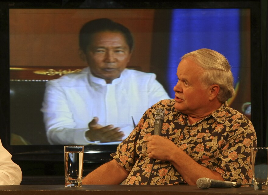 In this photo taken Wednesday, Feb. 23, 2011, former Manila Bureau Chief of The Associated Press David Briscoe talks about his coverage of the four-day People Power revolution 25 years ago during a television interview at suburban Quezon city, northeast of Manila, Philippines.