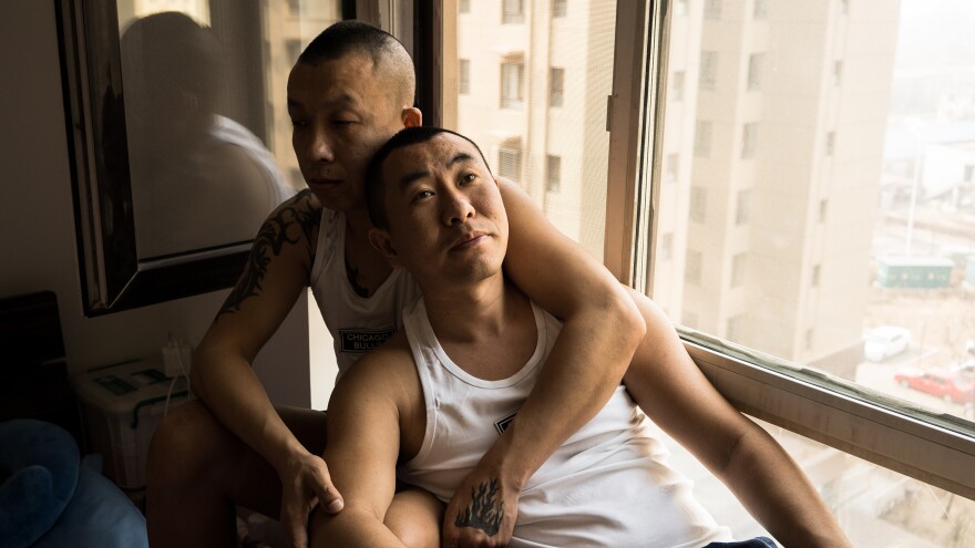 Zhongbao and Zhiyong in their apartment in Shenyang, China.