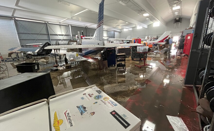 Flooding in an airport hangar containing small airplanes