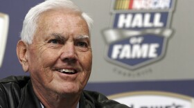 In this Oct. 16, 2009, file photo, former NASCAR driver and owner Junior Johnson smiles as he speaks to media about being named to the NASCAR Hall of Fame during a news conference at Lowe's Motor Speedway in Concord, N.C. Johnson, who won 50 NASCAR Cup Series races as a driver and 132 as an owner and was part of the inaugural class inducted into the NASCAR Hall of Fame in 2010, has died at 88. 