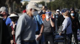 Older adults and first responders wait in line to receive a COVID-19 vaccine late last month at the Lakes Regional Library in Fort Myers, Fla.