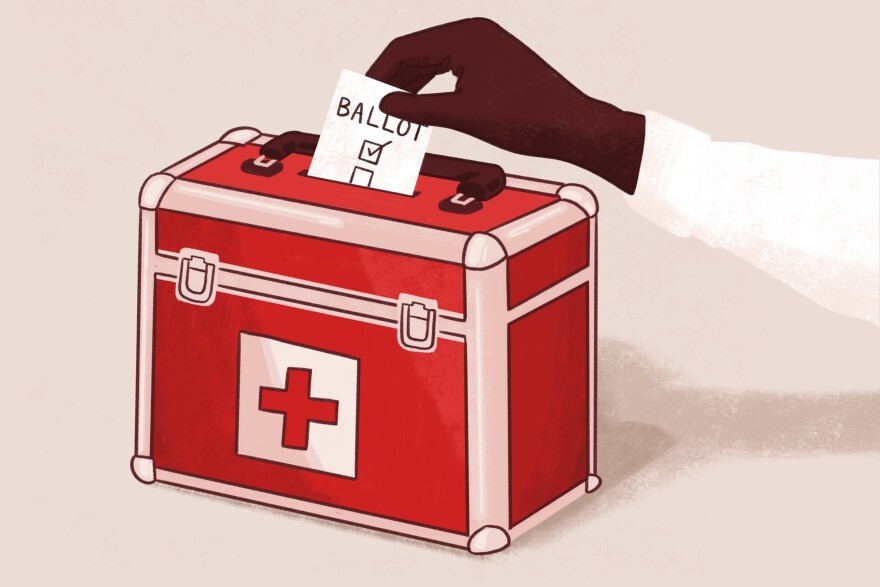 A hand places a marked ballot into a red ballot box with a red cross symbol.