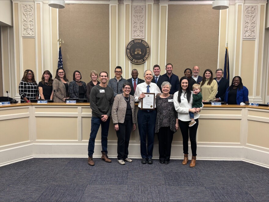 Stu Johnson (center) with his family (right) and Lexington Mayor Linda Gorton at a ceremony Nov. 21 honoring the veteran reporter