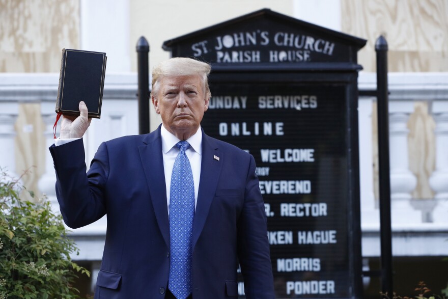 President Donald Trump holds a Bible as he visits outside St. John's Church across Lafayette Park from the White House Monday, June 1, 2020, in Washington. Part of the church was set on fire during protests on Sunday night.
