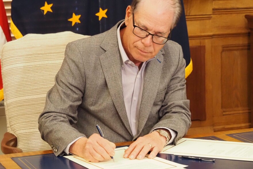Gov. Mike Braun signs a pair of executive orders dealing with unemployment insurance in his Statehouse office on Thursday, Feb. 27, 2025.