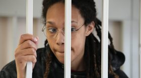 WNBA star and two-time Olympic gold medalist Brittney Griner stands in a cage at a court room prior to a hearing, in Khimki just outside Moscow, Russia, Tuesday, July 26, 2022. American basketball star Brittney Griner has returned to a Russian courtroom for her drawn-out trial on drug charges that could bring her 10 years in prison if convicted. (AP Photo/Alexander Zemlianichenko, Pool)