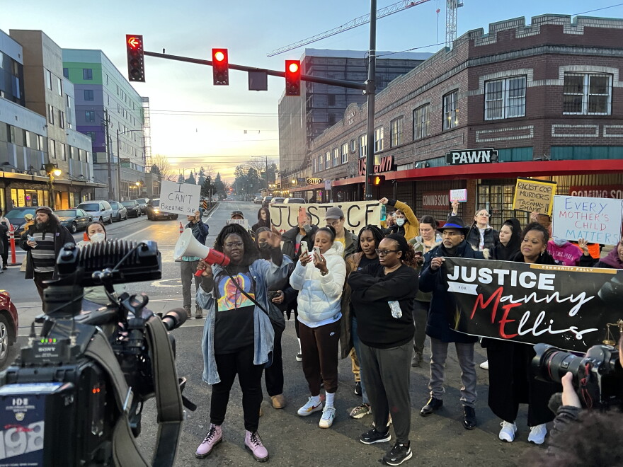 Family of Manuel Ellis and supporters gather at an intersection in Tacoma after a jury acquitted three police officers charged in Ellis' death.