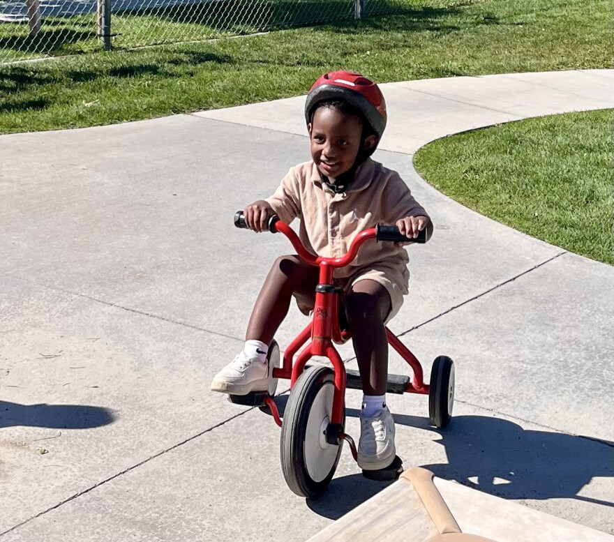 Preschoolers at Spokane's Logan/Lidgerwood Head Start Center ride tricycles during a recess break.