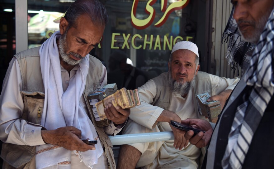 Afghanistan's currency has fallen by 12 percent against the U.S. dollar in the past year. Some Afghan money changers now prefer to covert their earnings to dollars.