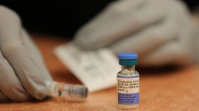 A nurse readies a measles, mumps and rubella vaccine.