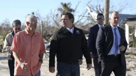 Mexico Beach Mayor Al Cathey, left, chats with Gov. Ron DeSantis, center, and Bay County Sheriff Tommy Ford while walking along Canal Parkway on Wednesday, Jan. 9, 2018 in Mexico Beach.