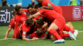 English Men's National Team captain Harry Kane, in blue armband, celebrates after scoring a goal in a 2018 match against Tunisia.