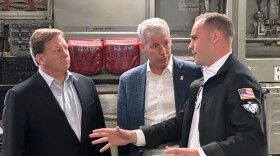 FILE - Energy Secretary Chris Wright, center, and Under Secretary of Defense Michael Duffey, left, listen as Isaiah Taylor, CEO of Valar Atomics, discusses a microreactor developed by Valar to generate nuclear power for the military and commercial customers, Feb. 15, 2026, in-flight, on board a C-17.