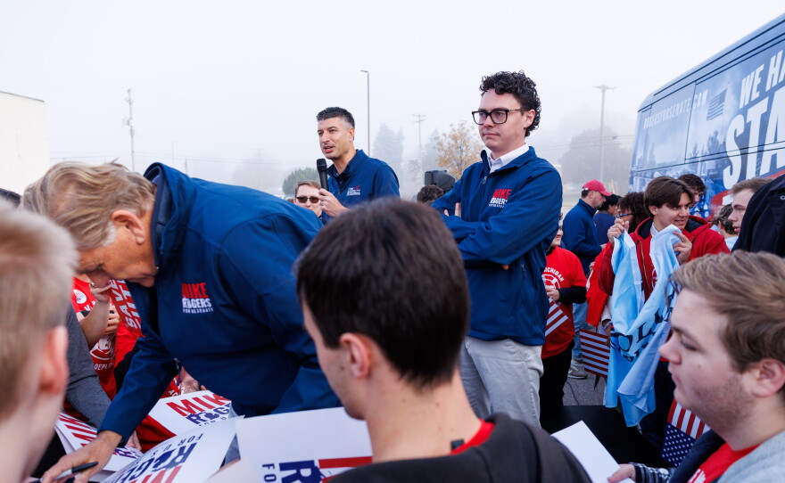 U.S. Rep. Tom Barrett, R-Charlotte, speaks in Lansing Township, Mich., on Oct. 24, 2026, as Republican U.S. Senate nominee Mike Rogers greets supporters during a stop on Rogers' "We Have a State to Save" bus tour.