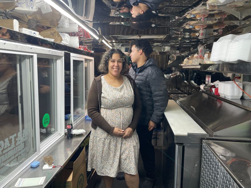 Vanessa Gonzalez, center, stands inside the food truck she's owned for ten years. 