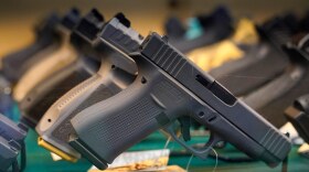 Handguns are displayed at a pawn shop Monday, July 18, 2022, in Auburn, Maine.