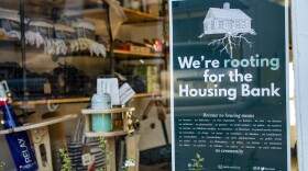 A sign in the Lani Beach Club storefront in Vineyard Haven shows support for the Martha's Vineyard Housing Bank. (Wilder Fleming/WBUR)