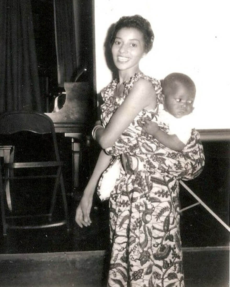 Lucienne Sanchez with her African infant son, swaddled in handmade cloth, in Liberia, circa 1954. He was baptized Anthony Joseph Sanchez and later took the name Rashann Sanchez.