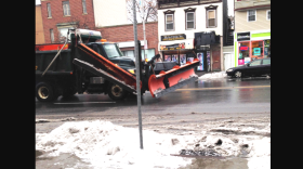 A snow plow cruises past the WAMC studios along Central Avenue in Albany.