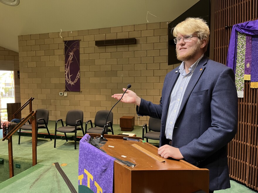 Community Minister Brooks Applegate stands at the pulpit of the Fort Myers Congregational United Church of Christ. On the average Sunday, the pews will be filled with around 70 people, with as many as 100 more joining via Zoom.