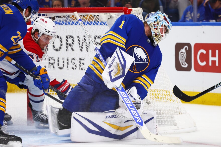 Montreal Canadiens center Jake Evans (71) puts the puck behind Buffalo Sabres goaltender Ukko-Pekka Luukkonen (1) during the second period in Game 5 of a second-round NHL hockey Stanley Cup playoff series, Thursday, May 14, 2026, in Buffalo, N.Y. (AP Photo/Jeffrey T. Barnes)