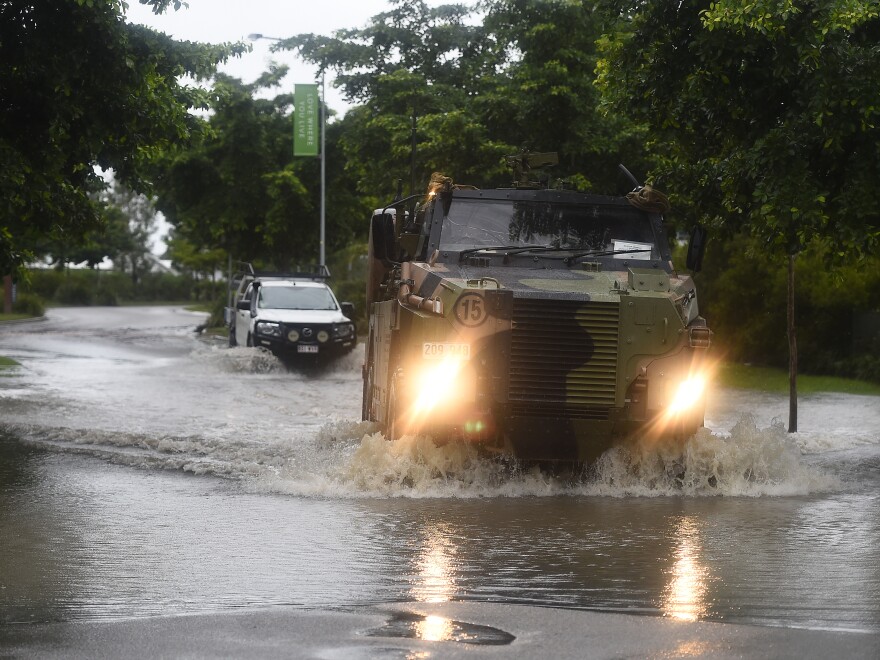 An Australian army Bushmaster vehicle crosses a flooded road in the suburb of Rosslea on Feb. 5 in Townsville, Australia. The city experienced nearly 12 inches of rain overnight, with monsoonal rainfall expected to continue though to the weekend.