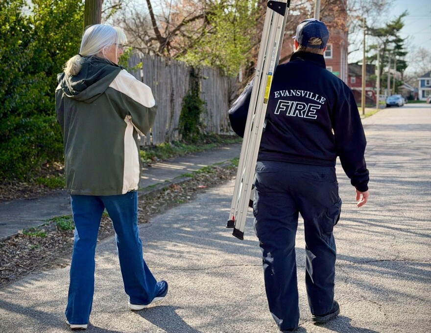 Two volunteers spread the word about fire safety in an Evansville neighborhood March14, 2026