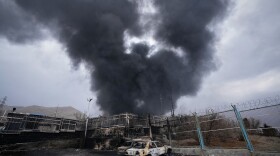 A thick plume of smoke rises from an oil storage facility hit by a U.S.-Israeli strike in Tehran, Iran, March 8, 2026.