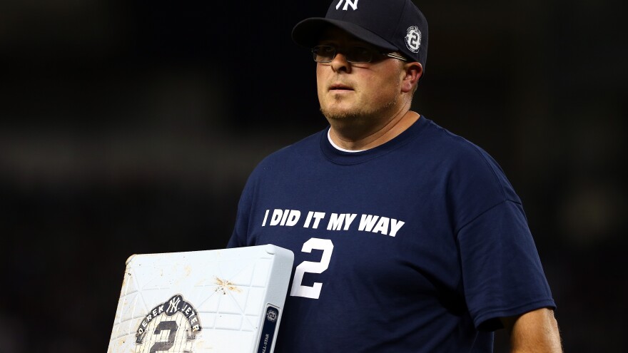 A grounds crew worker changes a base with Derek Jeter's uniform number on it during Thursday's game.