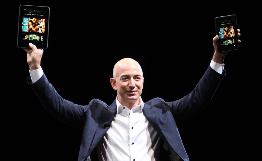 Amazon CEO Jeff Bezos holds up the Kindle Fire HD in two sizes during a press conference in Santa Monica, Calif., in September 2012.