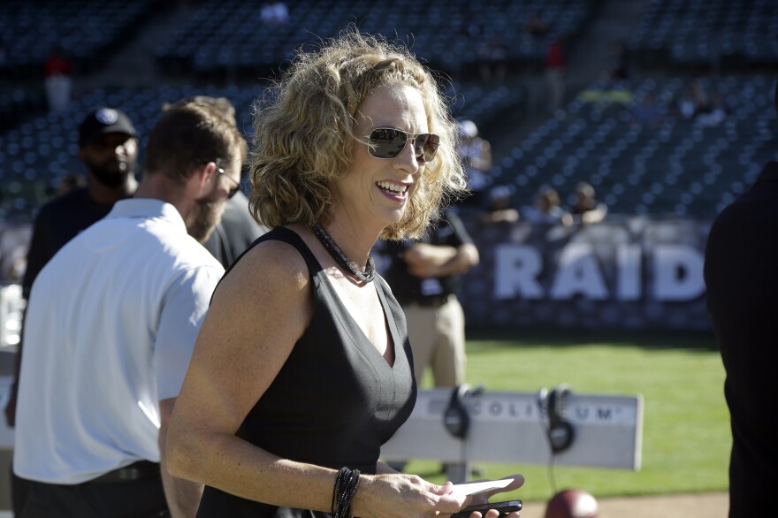 Announcer Beth Mowins walks on the field before a 2015 NFL preseason football game between the Oakland Raiders and the St. Louis Rams in Oakland, Calif.