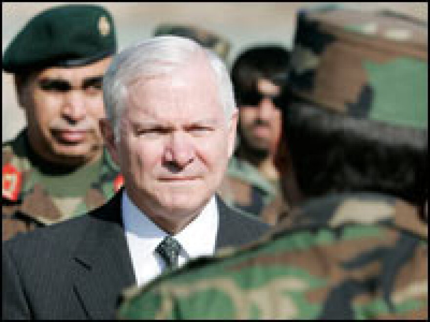 U.S. Defense Secretary Robert Gates is saluted by a member of the Afghanistan National Army during a tour of Kabul on Dec. 4.