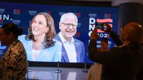 CHICAGO, ILLINOIS - AUGUST 16: People stand in front of a sign featuring Democratic presidential candidate U.S. Vice President Kamala Harris and Democratic Vice presidential candidate Minnesota Governor Tim Walz at the United Center before the start of the Democratic National Convention (DNC) on August 16, 2024 in Chicago, Illinois. The DNC runs from August 19-22. (Photo by Joe Raedle/Getty Images)