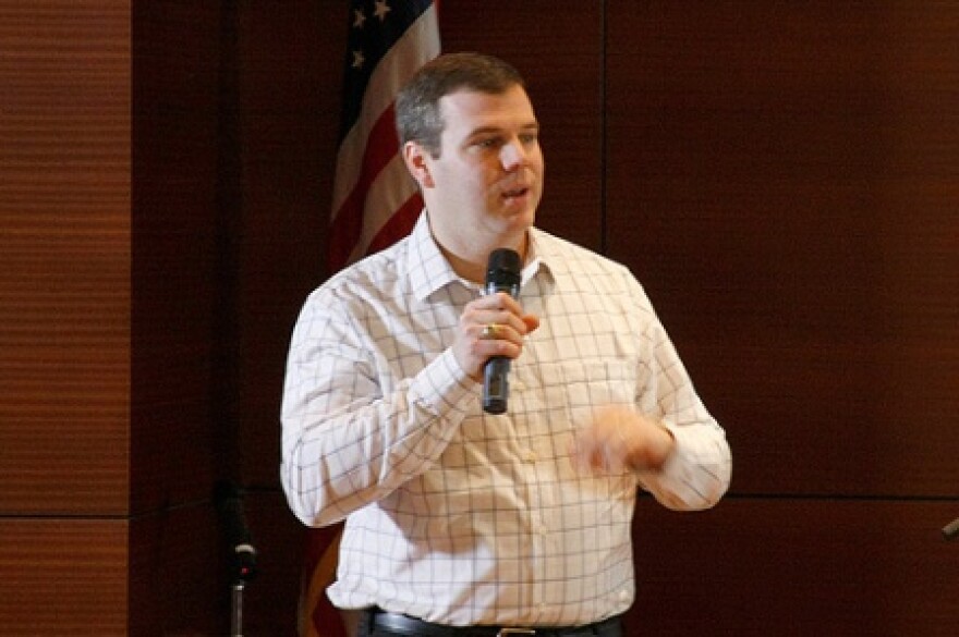 Cameron Cushman speaks to the crowd at the library.