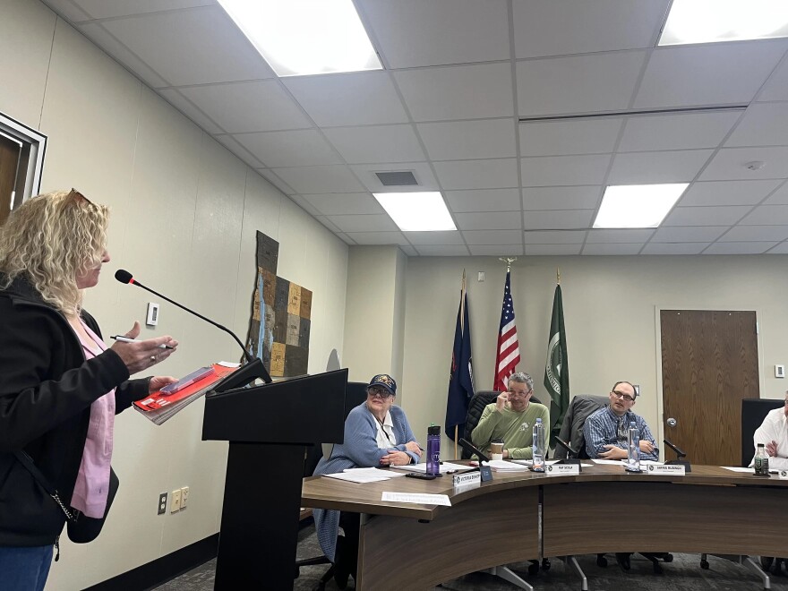Antrim County Clerk Victoria Bishop (seated at the left end of the table) listens as a resident addresses the county commission during a meeting earlier this month.
