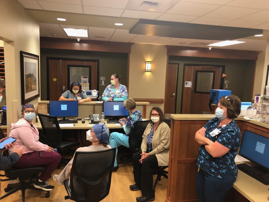 Christy Baxter (far right), director of critical care at Billings Clinic, meets with nurses in the hospital’s cardiopulmonary unit on Sept. 17. The unit houses overflow patients from the ICU.