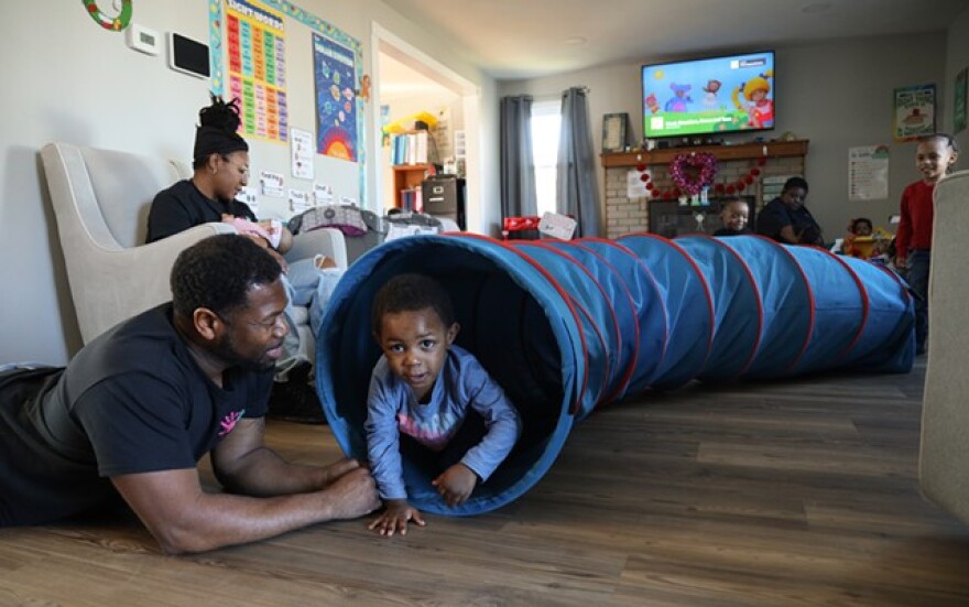 Richard Morris plays with 2-year-old Legend Sirman at Morris Munchkins Playhouse in Chili.