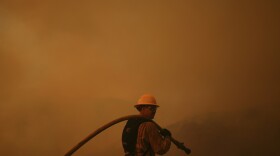 A firefighter monitors the advance of the Palisades Fire in Mandeville Canyon on Saturday, Jan. 11, 2025, in Los Angeles. (AP Photo/Eric Thayer)