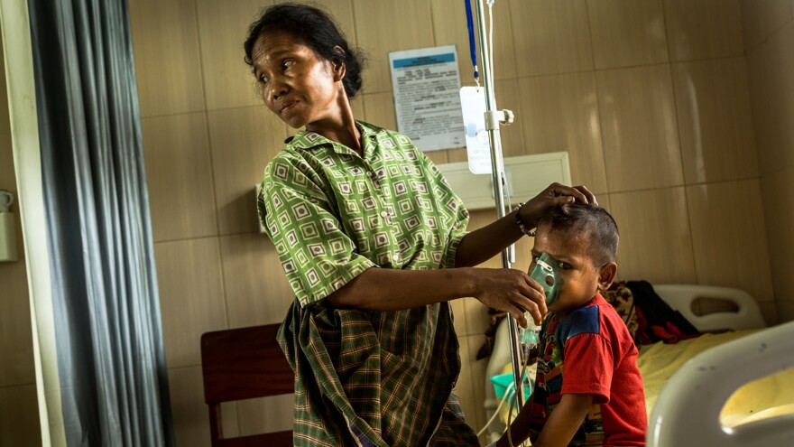 A mother tends to her child, who has pneumonia, in the pediatric ward of Karitas Hospital in Waitabula, a small town on Sumba Island.