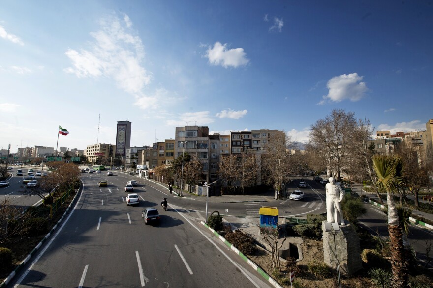 A typically busy highway in Tehran has only a few cars on the road.