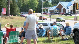 Northwood residents wave to departing tourists at the end of the Labor Day weekend