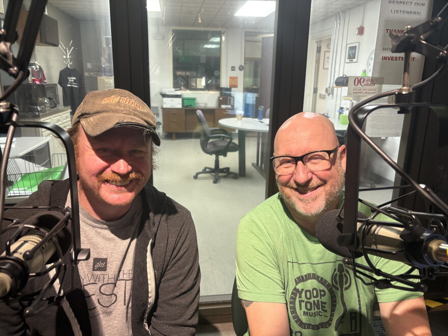 Jake Kuhlman (Left) and Jeff Krebs (Right) of Yooptone Music sitting side-by-side in our main studio, looking forward together and smiling.