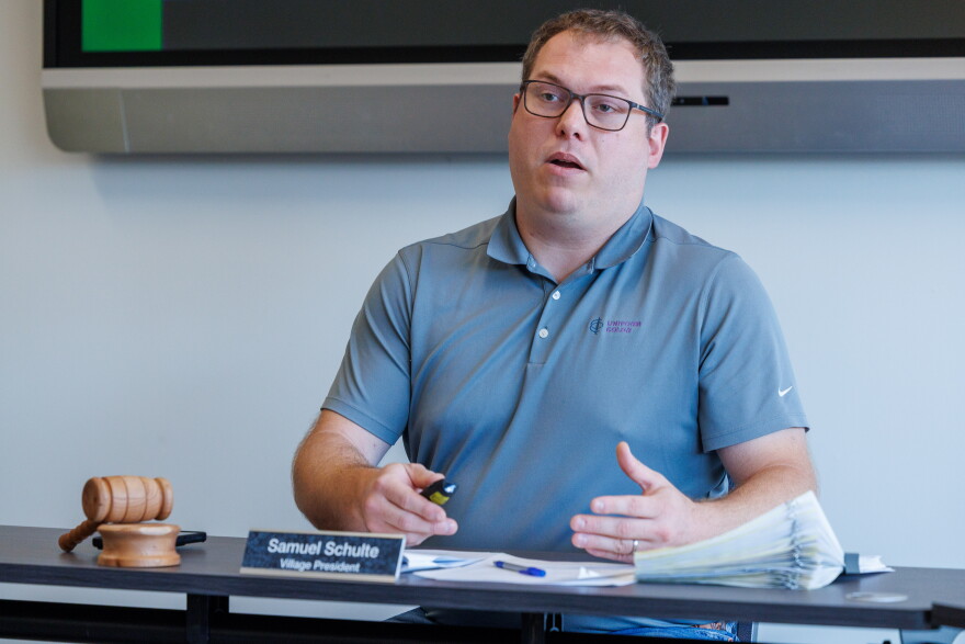 Webberville Village Council President Sam Schulte speaking at a table.