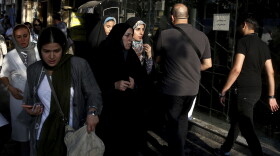 People make their way on a sidewalk in downtown Tehran, Iran, Monday, July 30, 2018. Iran's currency has dropped to a record low ahead of the imposition of renewed American sanctions, with many fearing prolonged economic suffering or possible civil unrest. (Ebrahim Noroozi/AP)