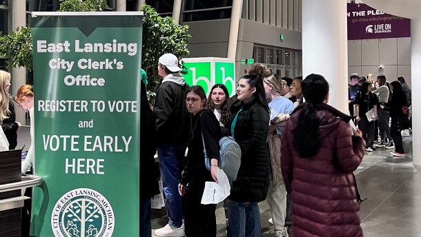 Michigan State University students line up to register and vote at the East Lansing City Clerk's Satellite Office inside Brody Hall on campus.  