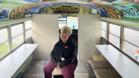 Charlotte artist Bunny Gregory sits inside the “Underground Art Bus.” She hopes to fully renovate the bus and add solar panels to power it. Gregory plans to teach art to children in the city’s low-income Corridors of Opportunity.